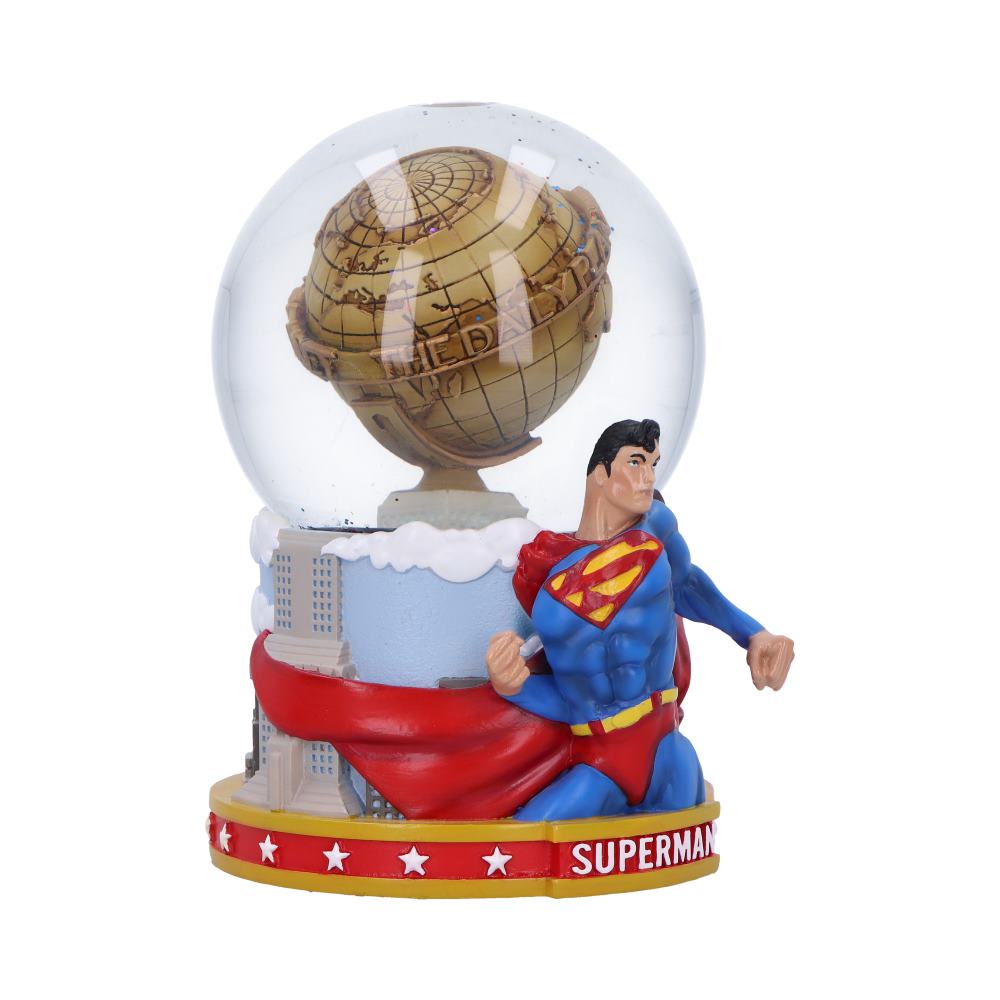 A snow globe featuring the superhero Superman in a dynamic pose with the Daily Planet building inside the globe.