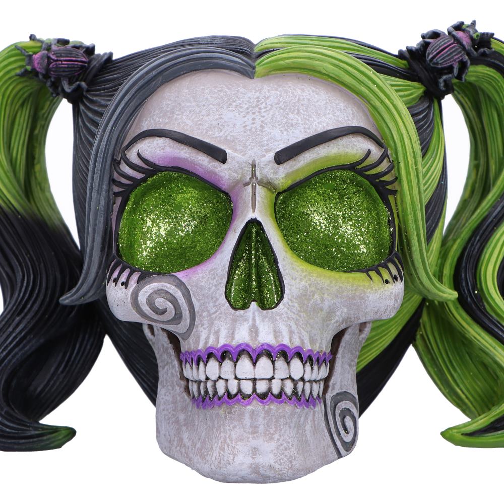 Skull with glitter green eyes, purple accents, and colorful hair resin figurine