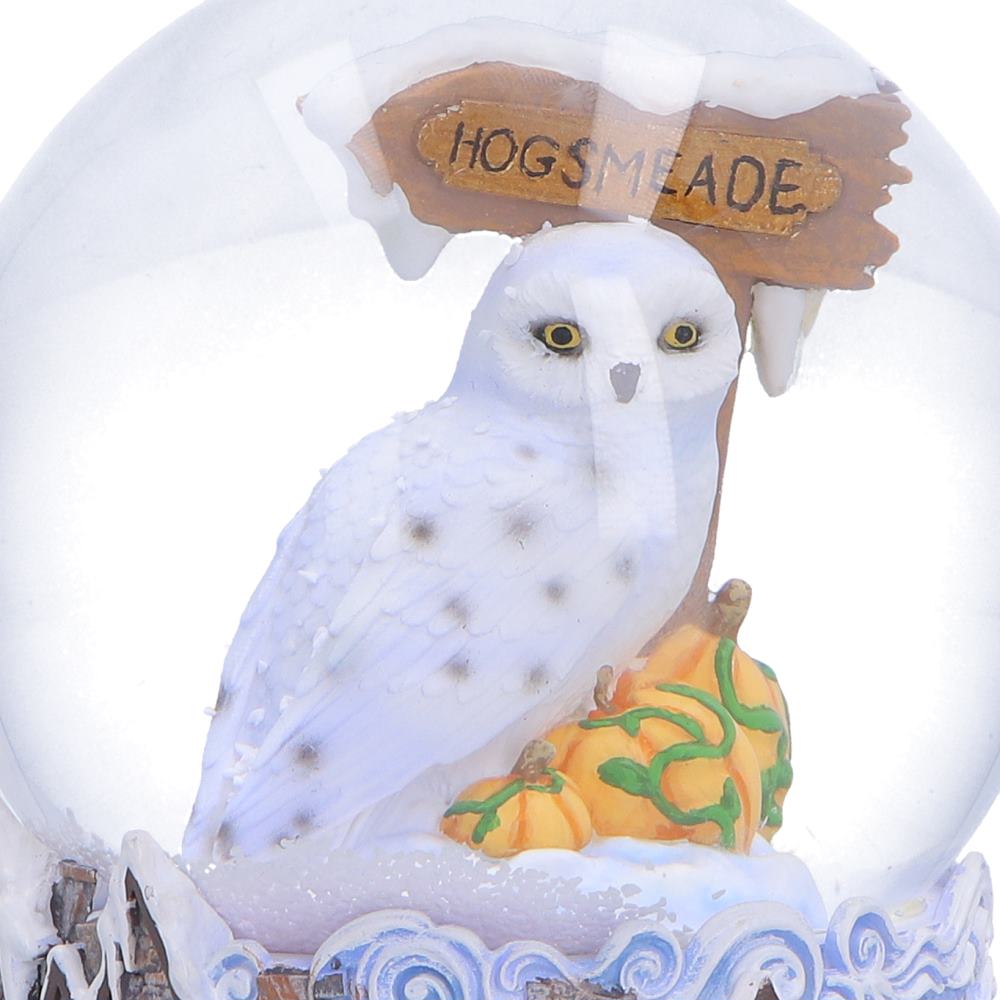 Close-up of Hedwig and Hogsmeade sign inside globe
