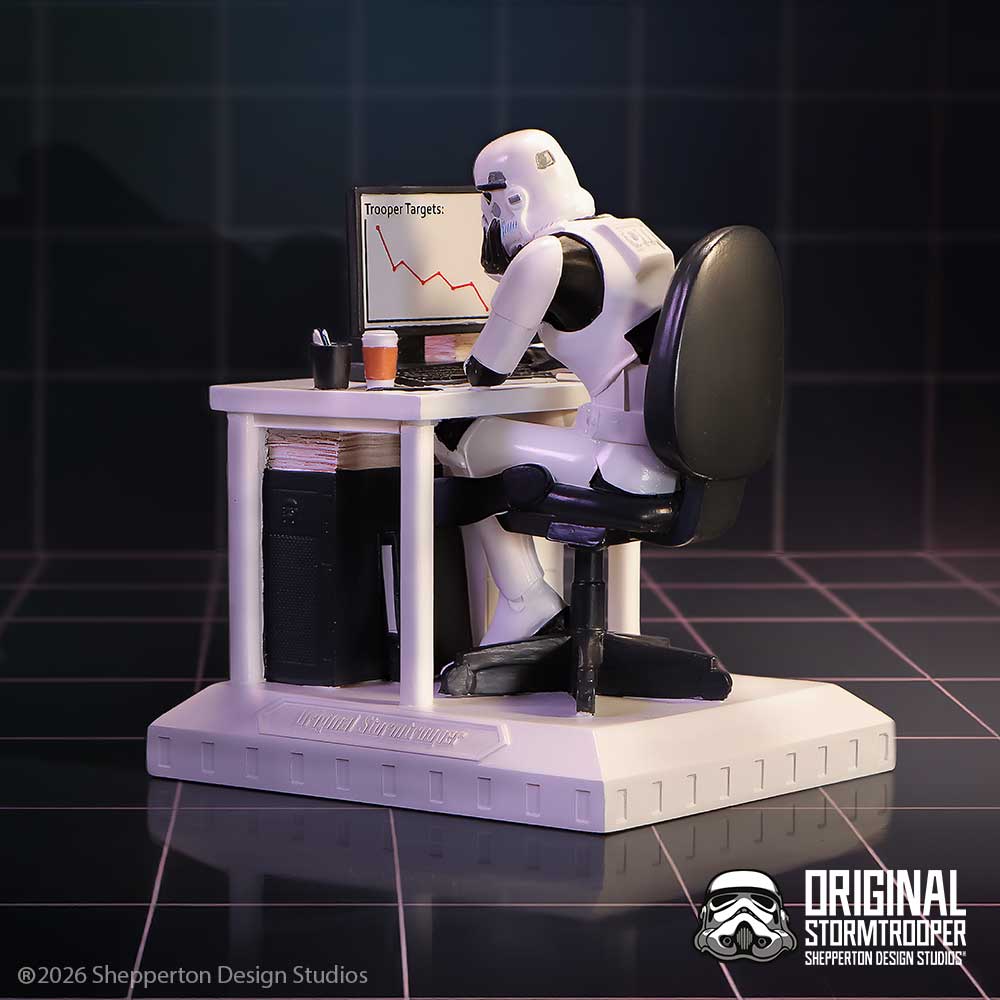Stormtrooper figure sitting at a desk with a computer, working on financial charts.