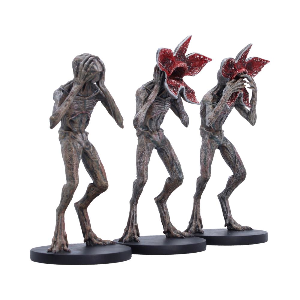 Three stylised Demogorgons in See No Evil Hear No Evil Speak No Evil poses