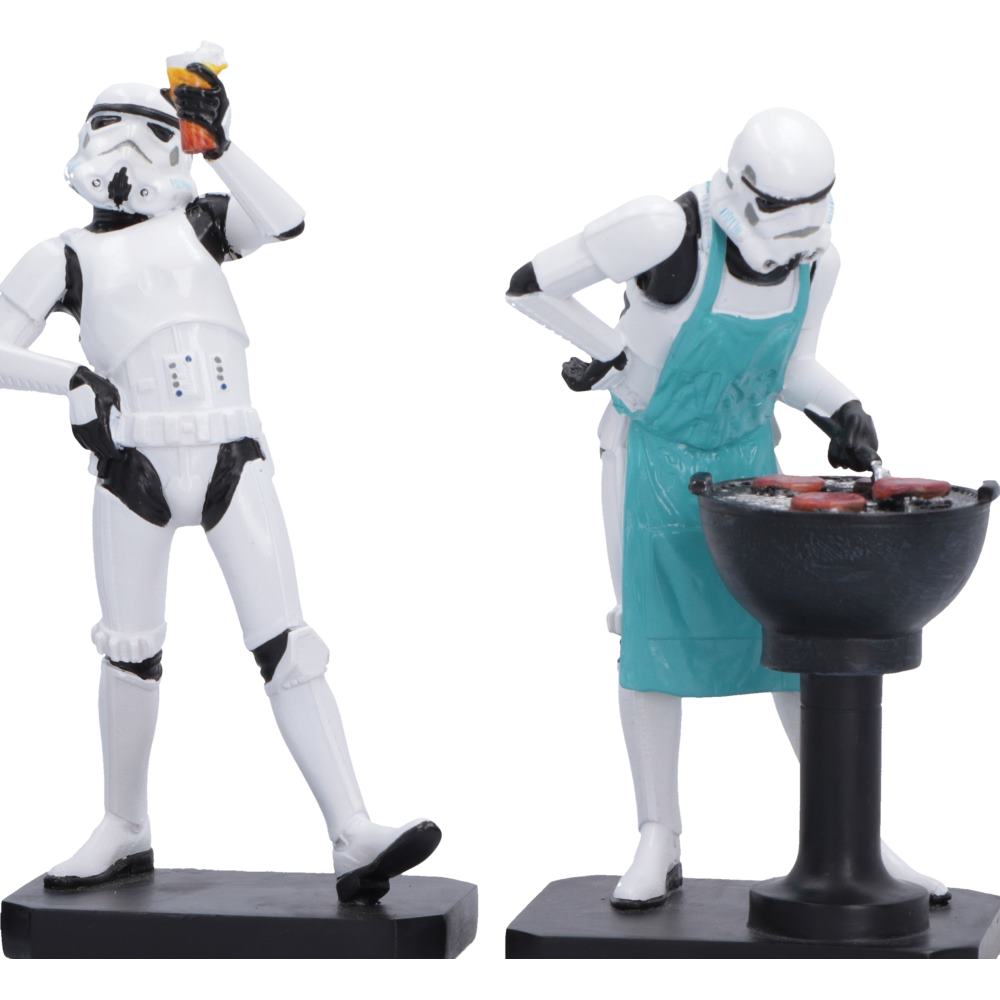 Two Star Wars Stormtrooper figurines on black bases. One Stormtrooper holds a drink near its face, while the other wears a teal apron cooking burgers at a barbecue.