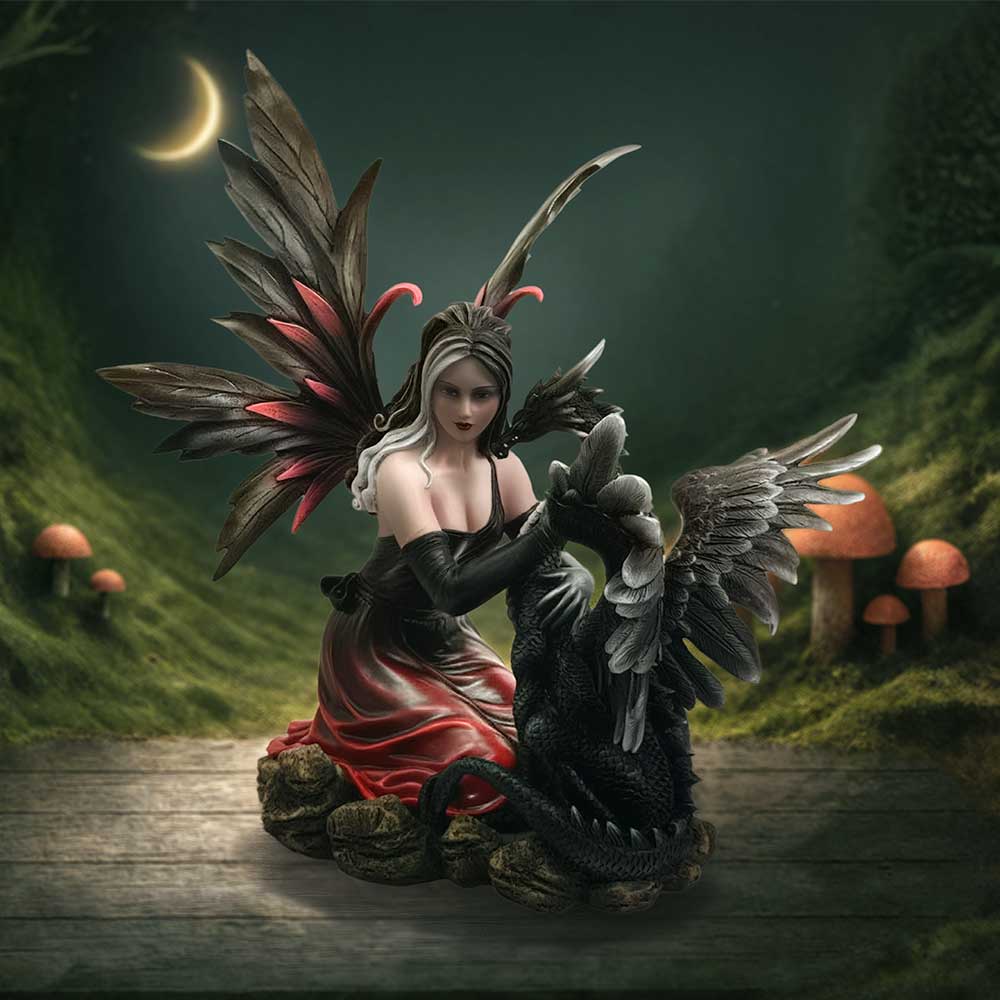 Gothic fairy and dragon figurine displayed as fantasy decor