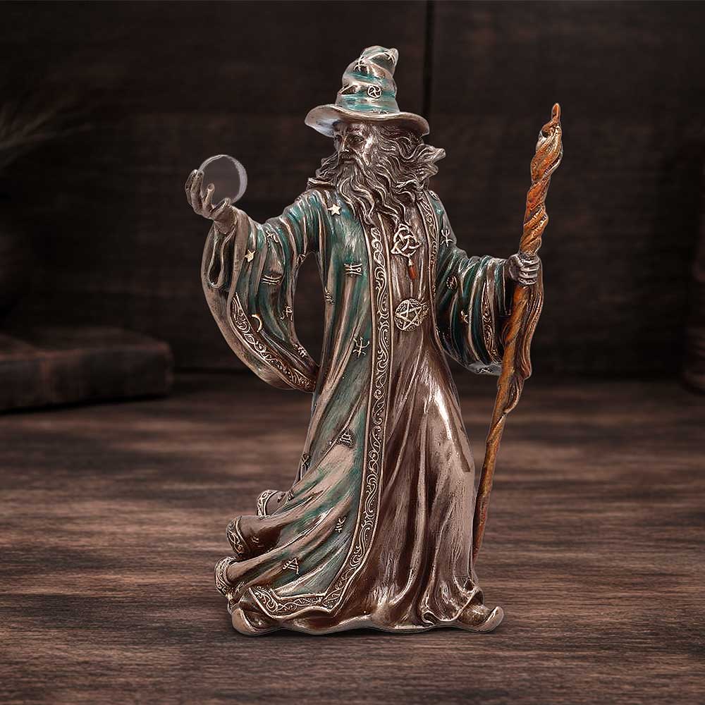 Statue of a wizard with a staff and crystal ball mystical wizard home décor on display