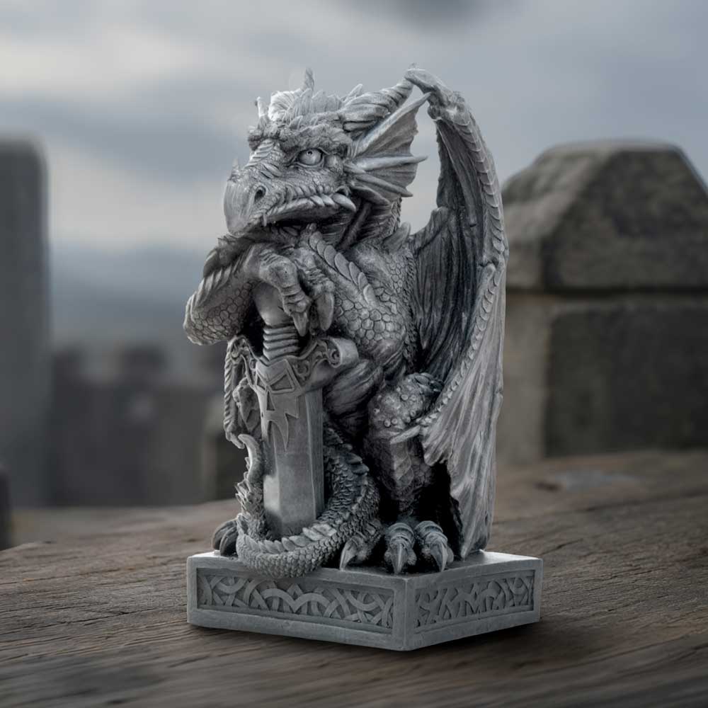 A detailed gray fantasy dragon figurine holding a sword, mounted on a carved rectangular sturdy base on display