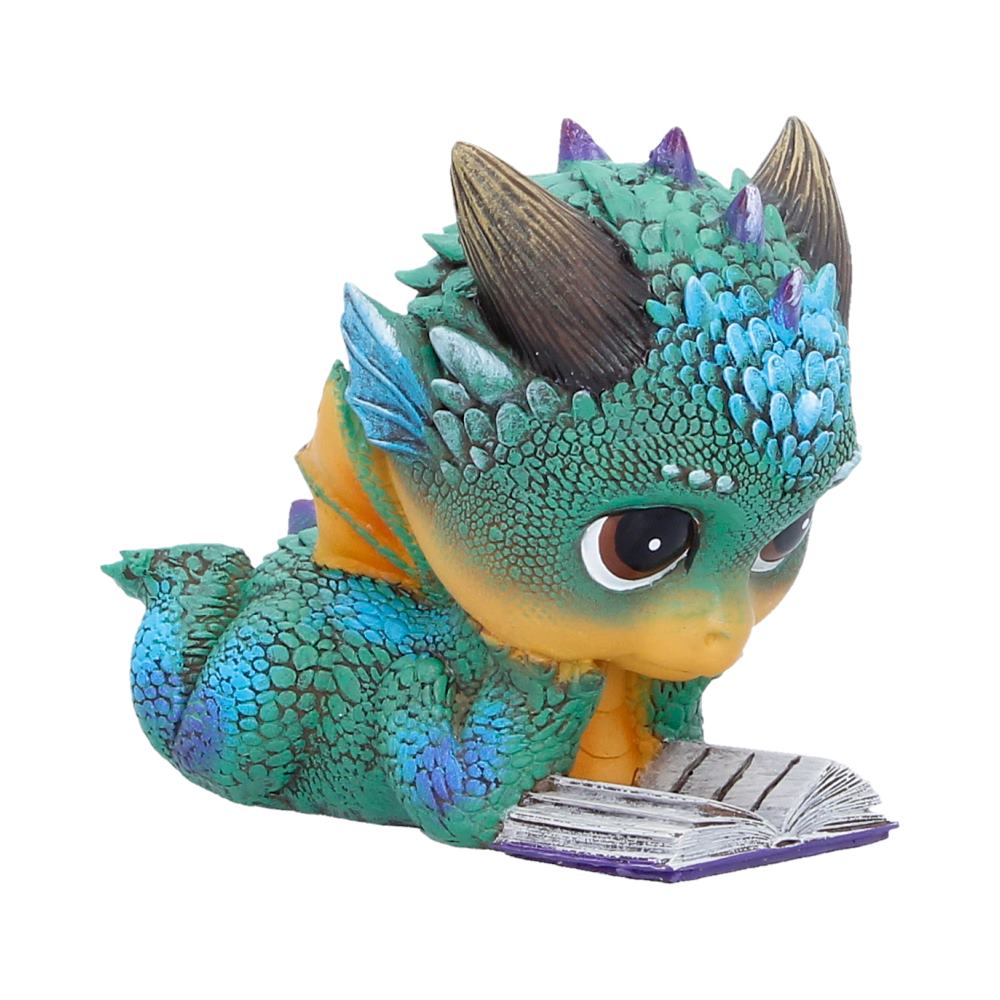 Cute dragon figurine reading a small book detail