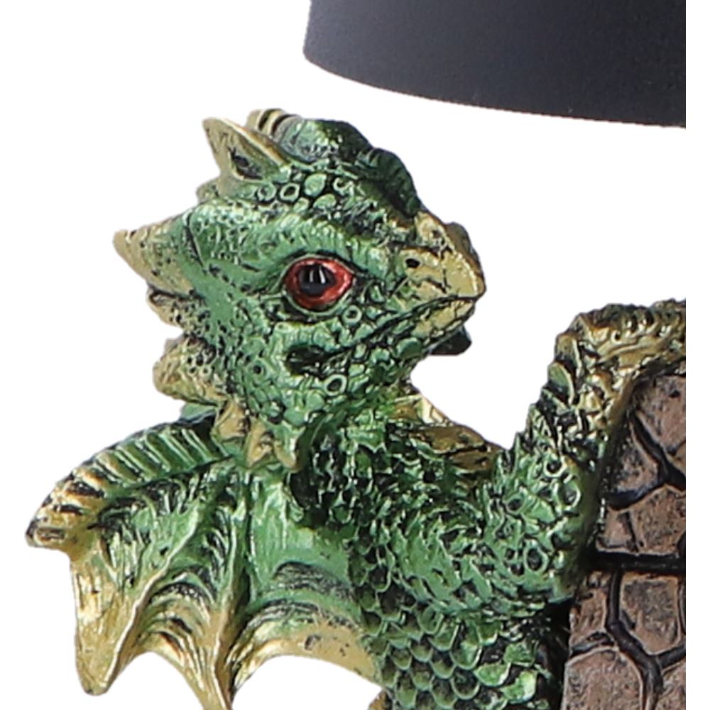 Close-up of green dragon climbing castle wall