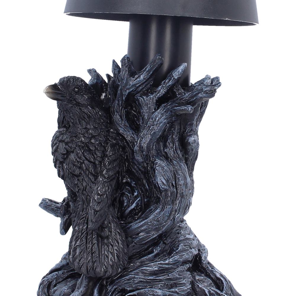 Close-up of black raven figurine on lamp