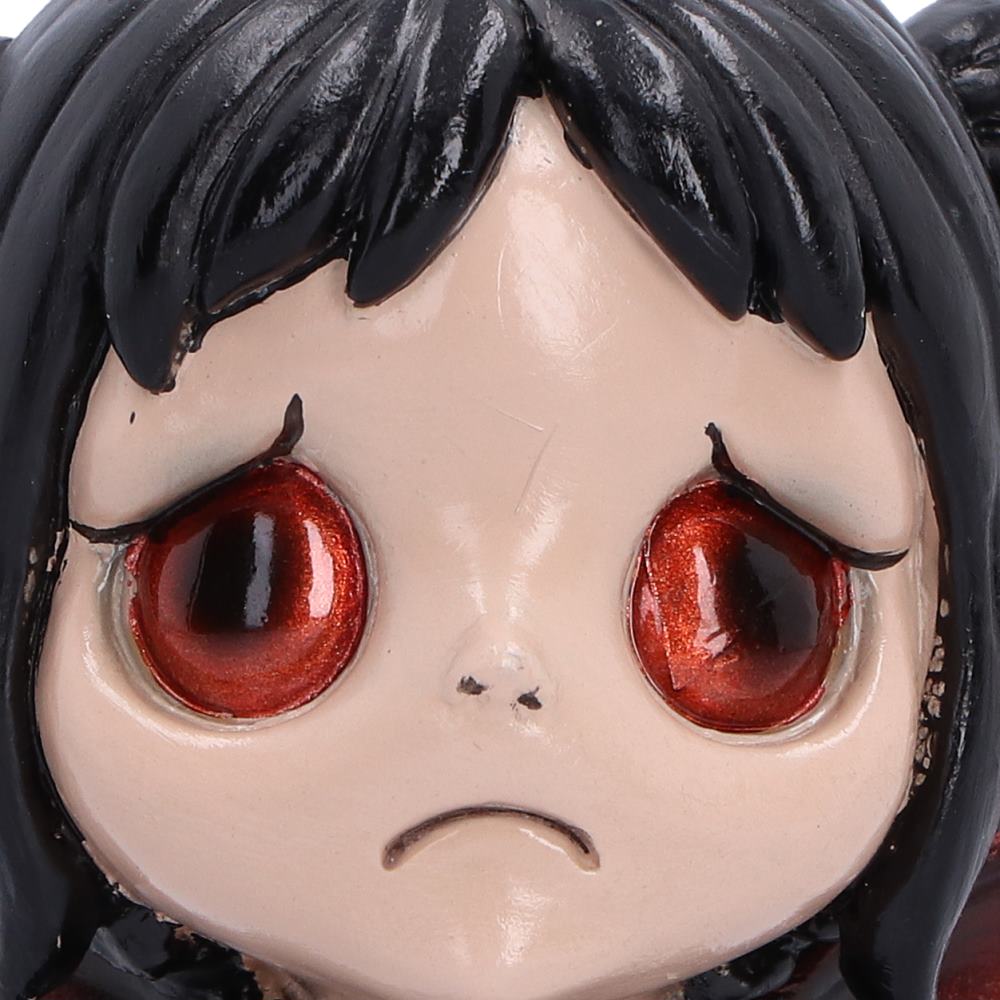 Close-up of Spirit Fairy Mortina with large red eyes and distinctive frown with black hair, pale skin, and large glossy red eyes.